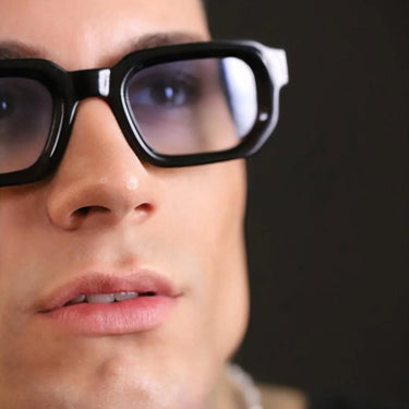 Genovenses · striking black sunglasses with blue lenses