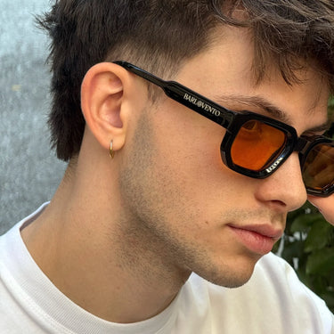 Medano · striking black sunglasses with orange lenses