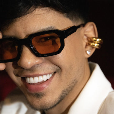 Medano · striking black sunglasses with orange lenses